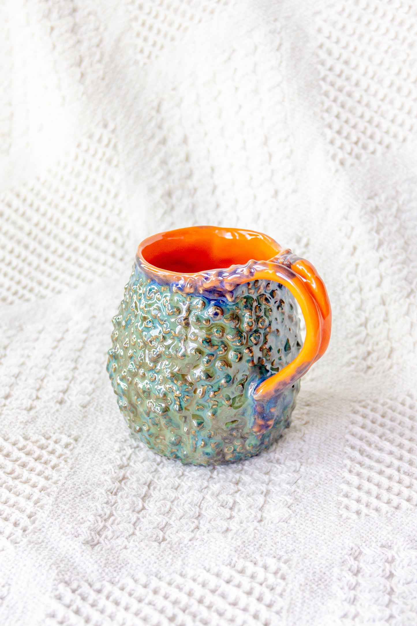 Kubek ceramiczny „Rafflesio” zielono-pomarańczowy