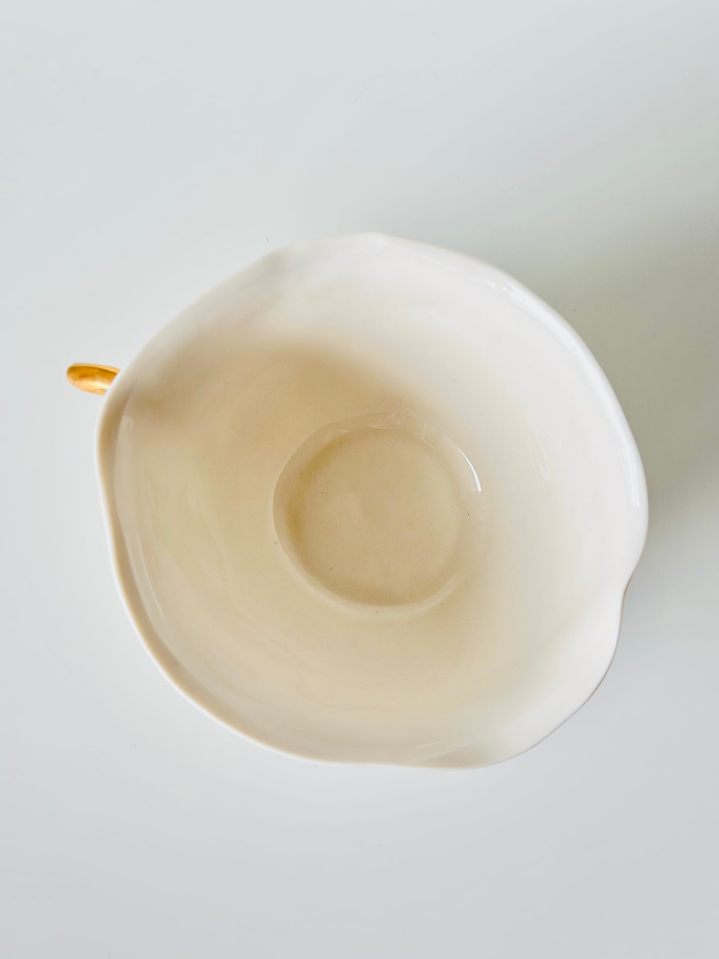 Tasse en porcelaine avec anse dorée