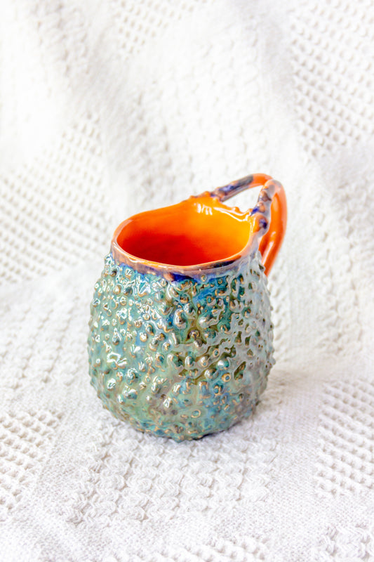 Kubek ceramiczny „Rafflesio” zielono-pomarańczowy