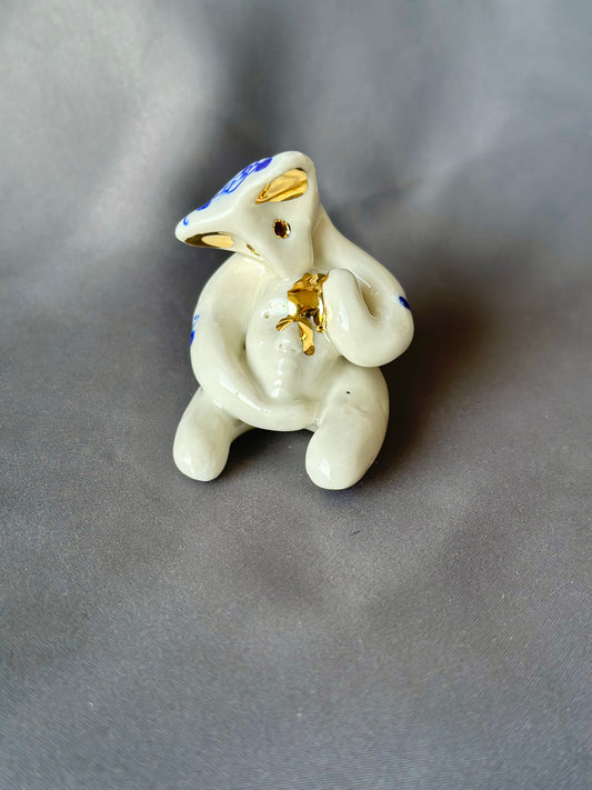 Werling avec masque, figurine en porcelaine dorée